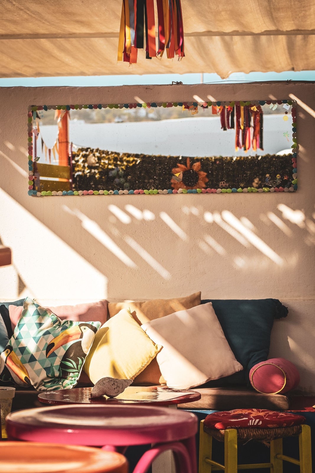 A patio sofa holds cushions of different shapes, illustrating why your actual cushion stack matters when comparing storage interiors; no storage box or reviewed product is identified.